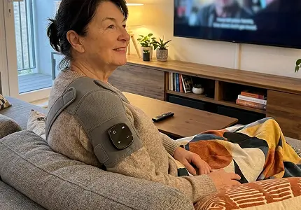 Customer using Vital Shoulder Massager at home