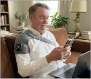 Customer wearing Vital Shoulder Massager outdoors